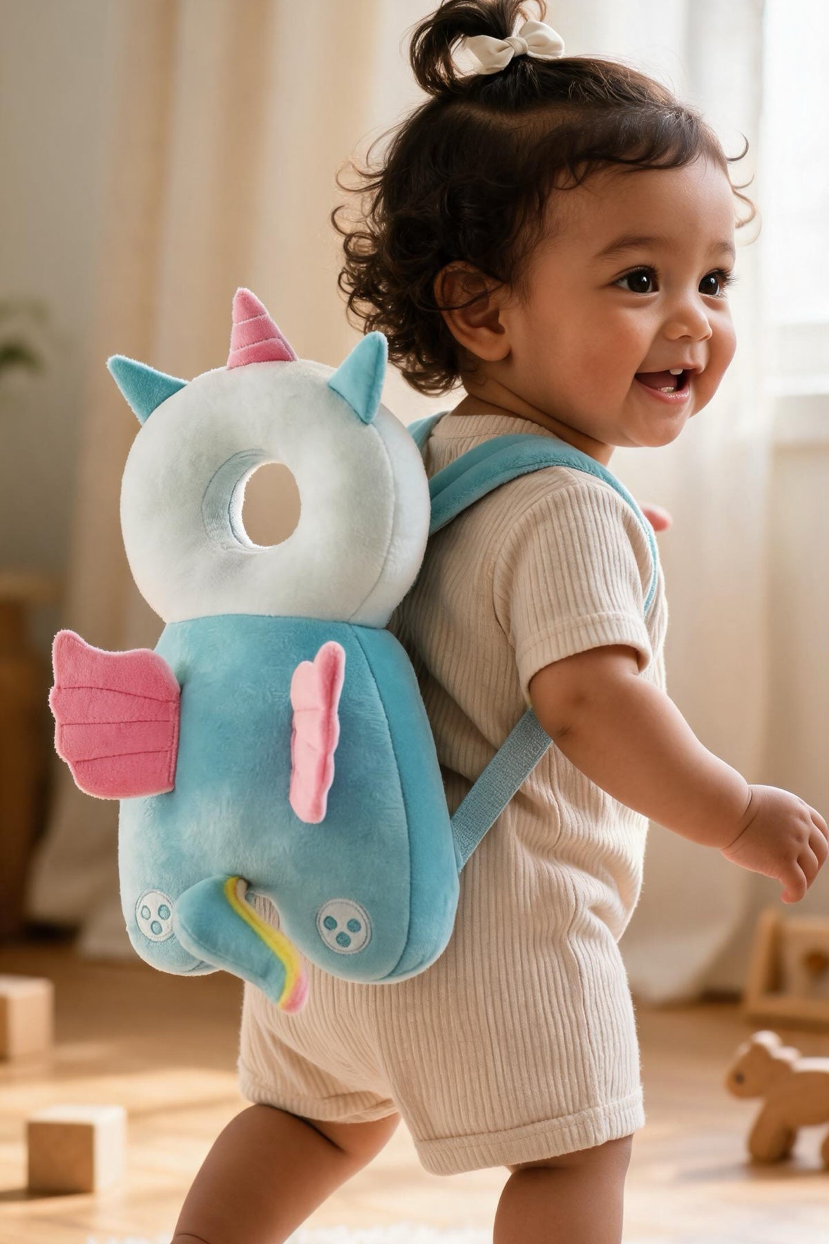 Baby walking on a rug wearing a unicorn head protector backpack